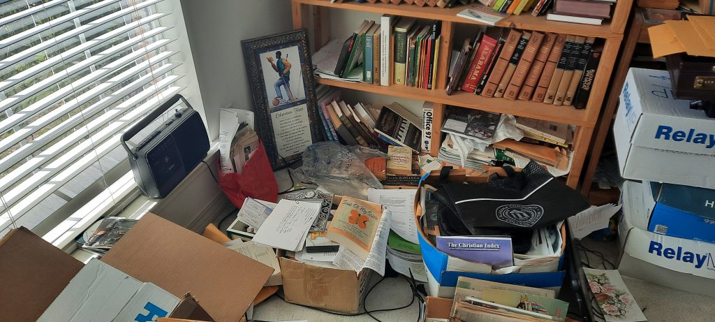 Picture of an unorganized office shelf